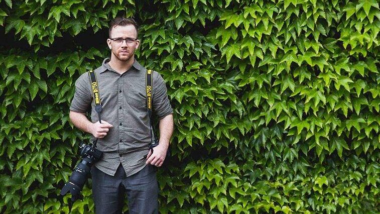 Portrait of Jason Huckle Photography infront of green foliage by Aaron Storry Photography