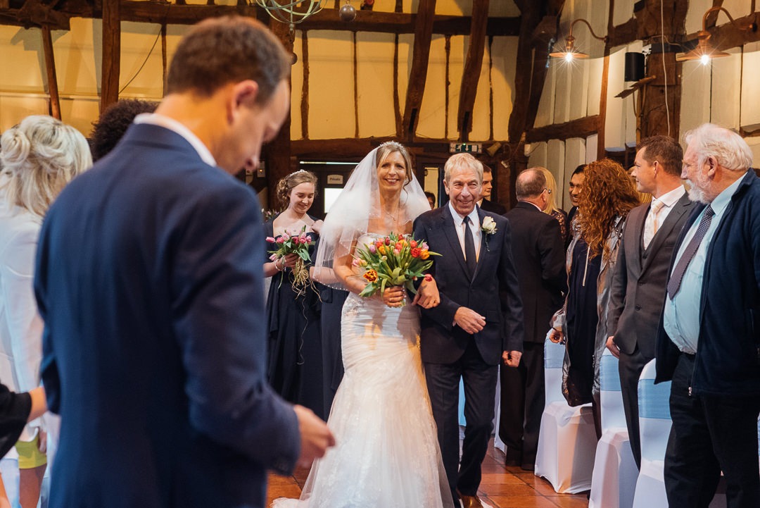 Bride walks down the aisle at the Tithe Barn, Bedford.