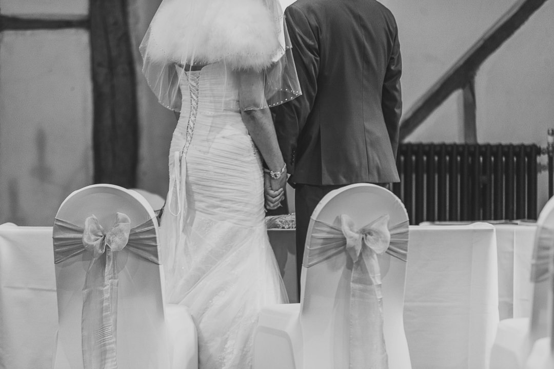 Bride and Groom Hold Hands at the Tithe Barn, Bedford.