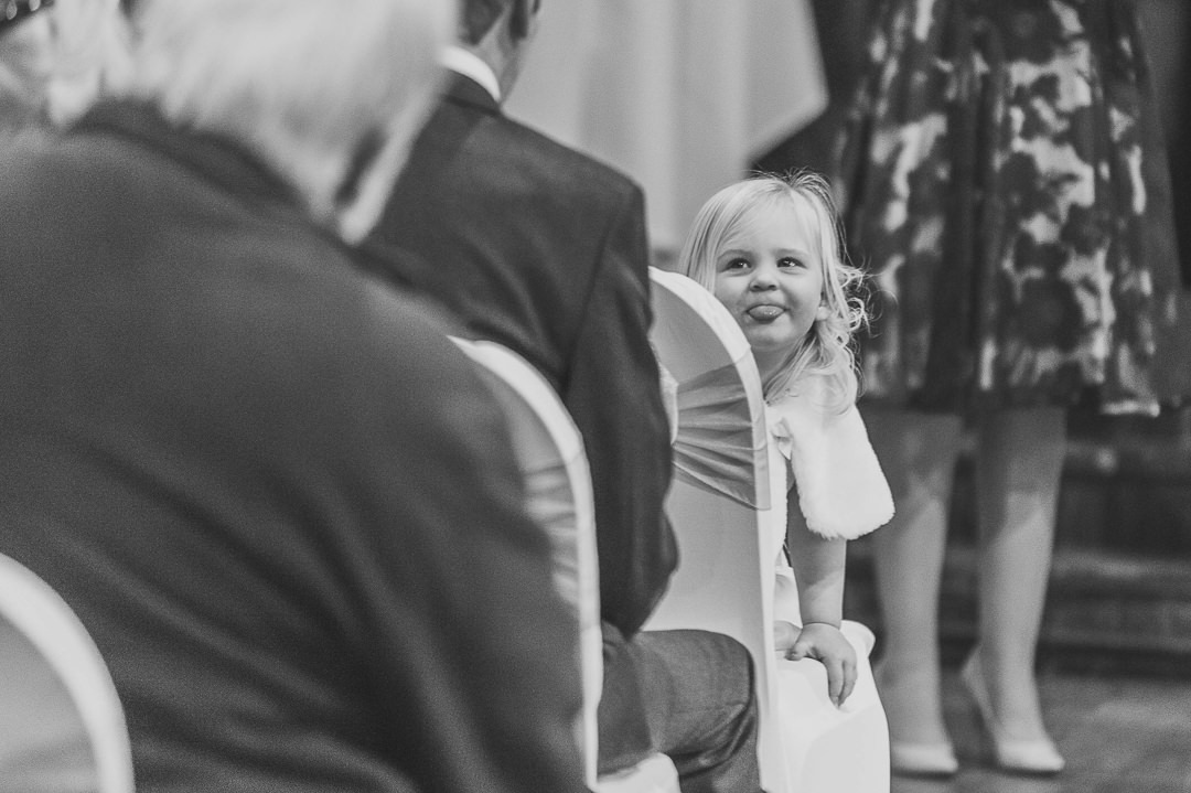 Flower Girl sticking tongue out at the Tithe Barn, Bedford.