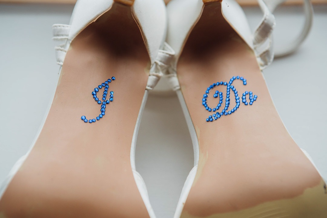 Underside of wedding shoes showing "I DO"