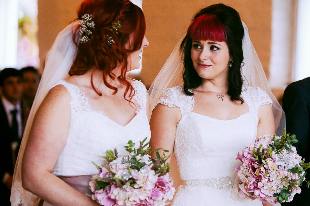 Brides look at each other at LGBTQ+ Wedding