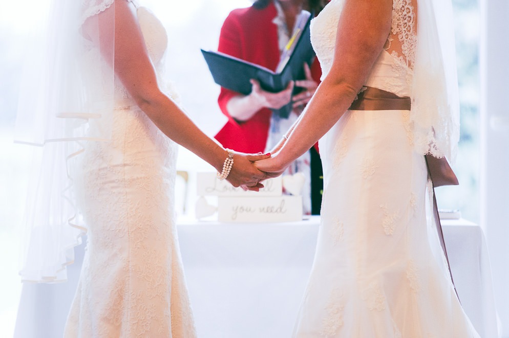Holding hands at LGBTQ+ Wedding