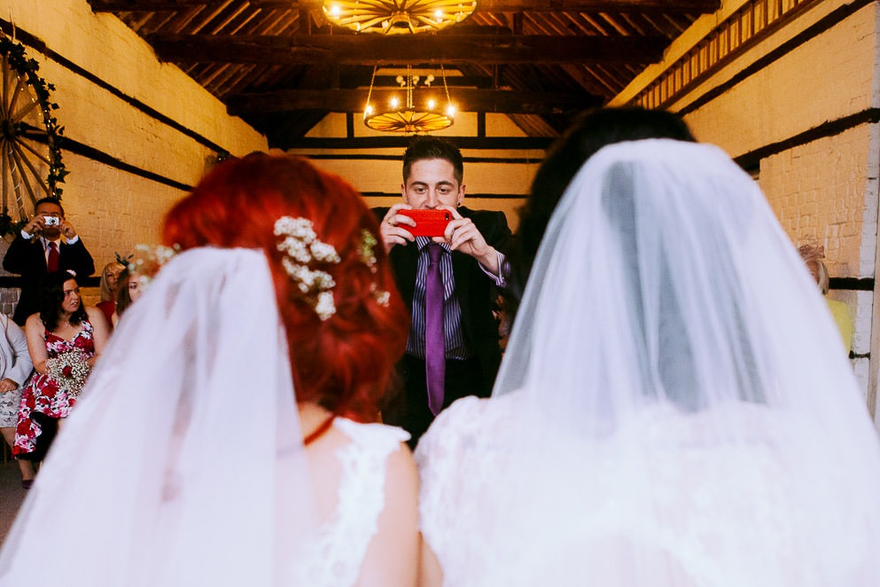 Guest taking photo of brides at LGBTQ+ Wedding