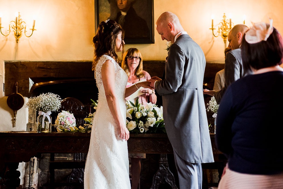 Bride and Groom exchanging rings at Sulgrave Manor