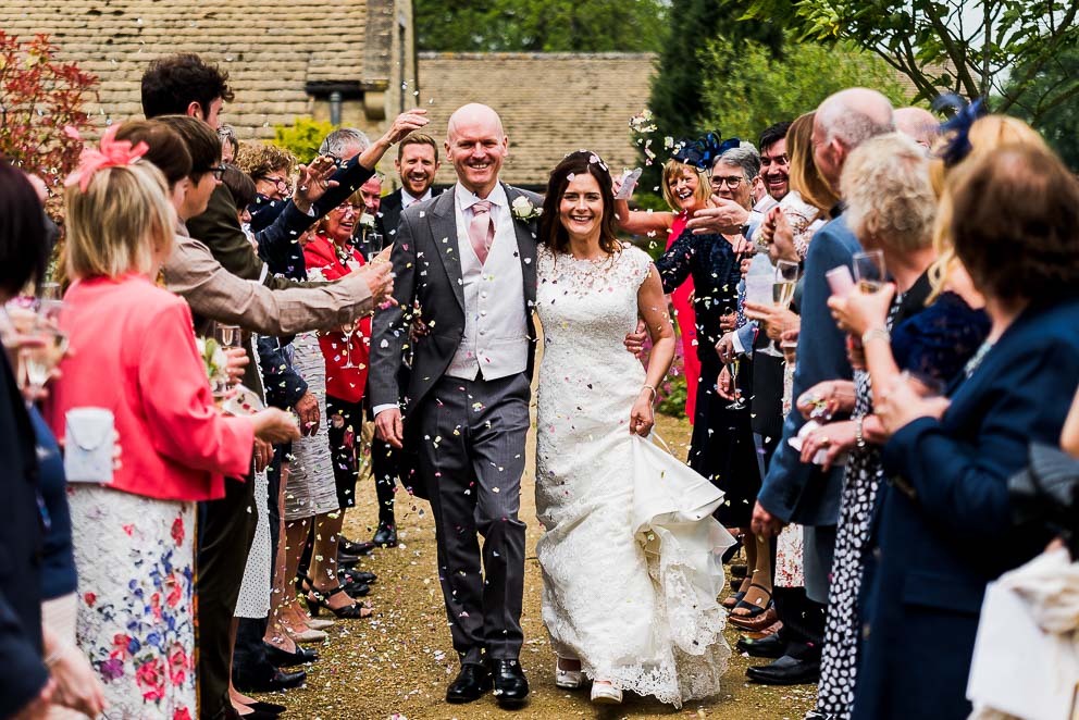 Bride and Groom walk through a confetti Line at Sulgrave Manor