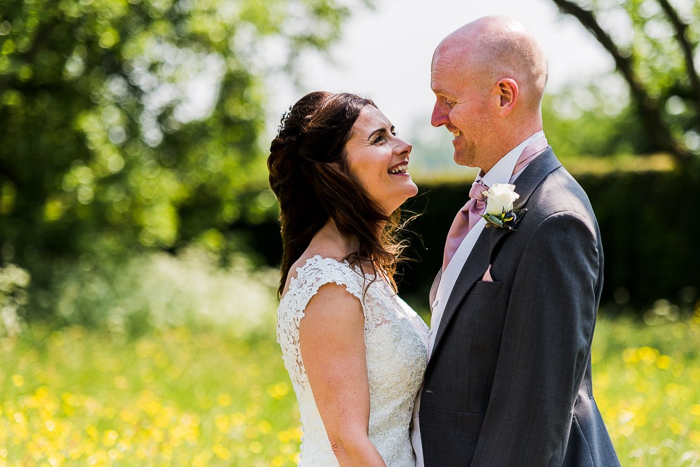Bride and groom smiling at Sulgrave Manor